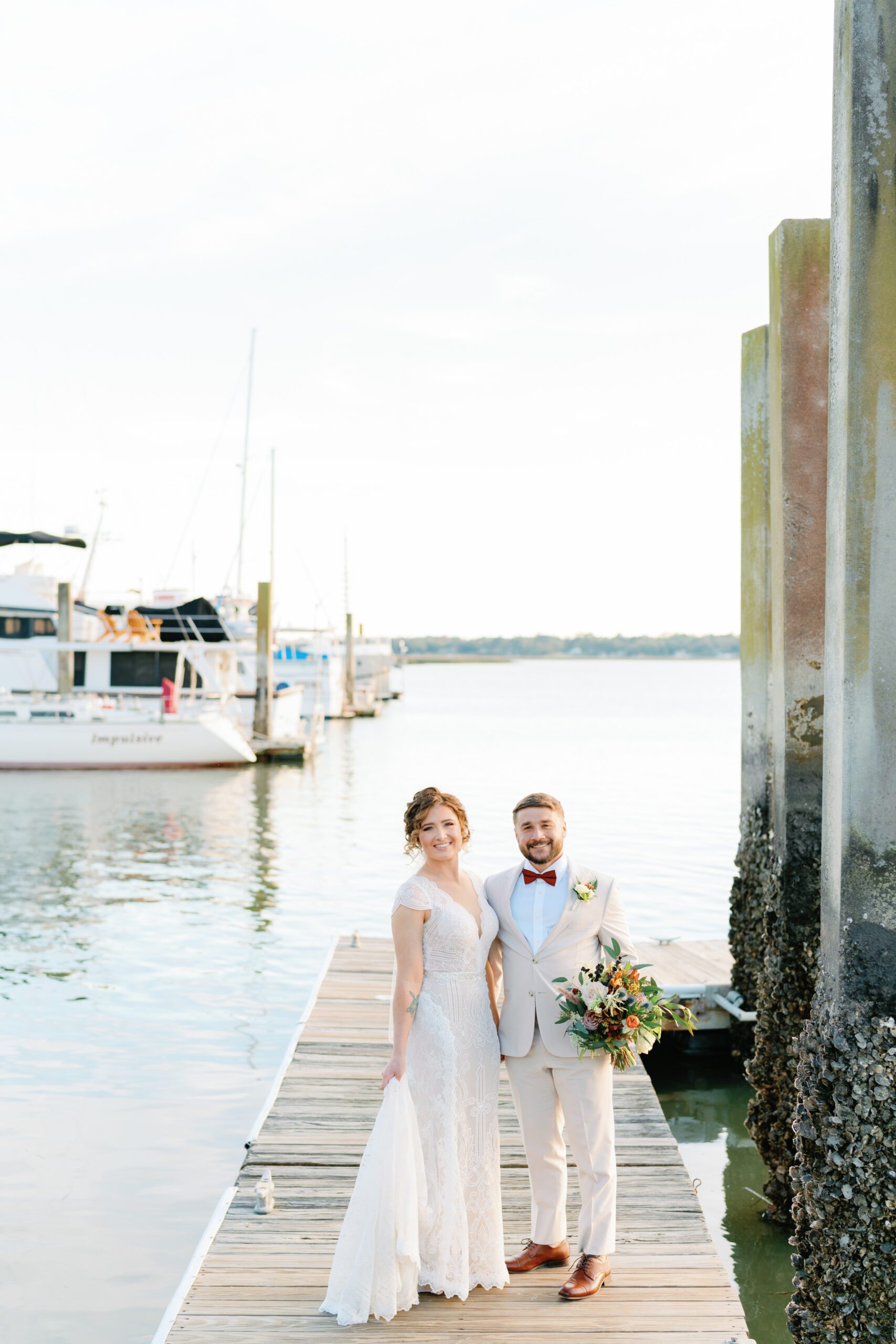 Bride and groom along the docks in beaufort sc on their wedding day captured by beaufort wedding photographer